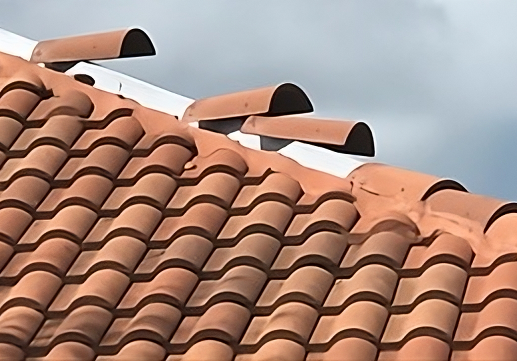 A roof with some red tiles on it